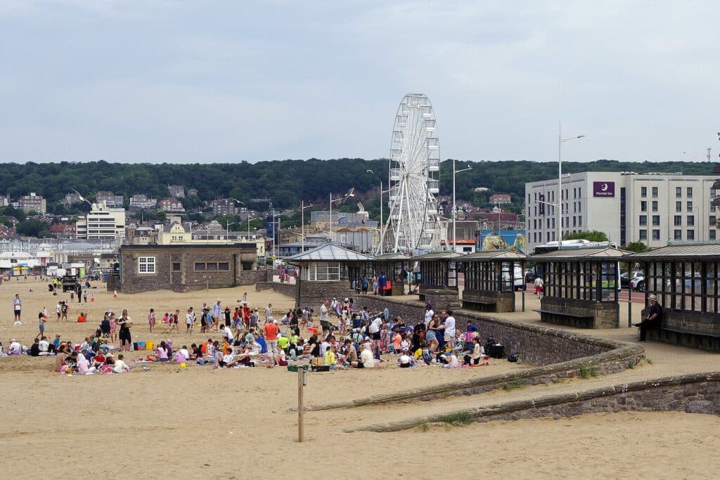 Families on the beach at Weston-super-Mare with the seafront behind