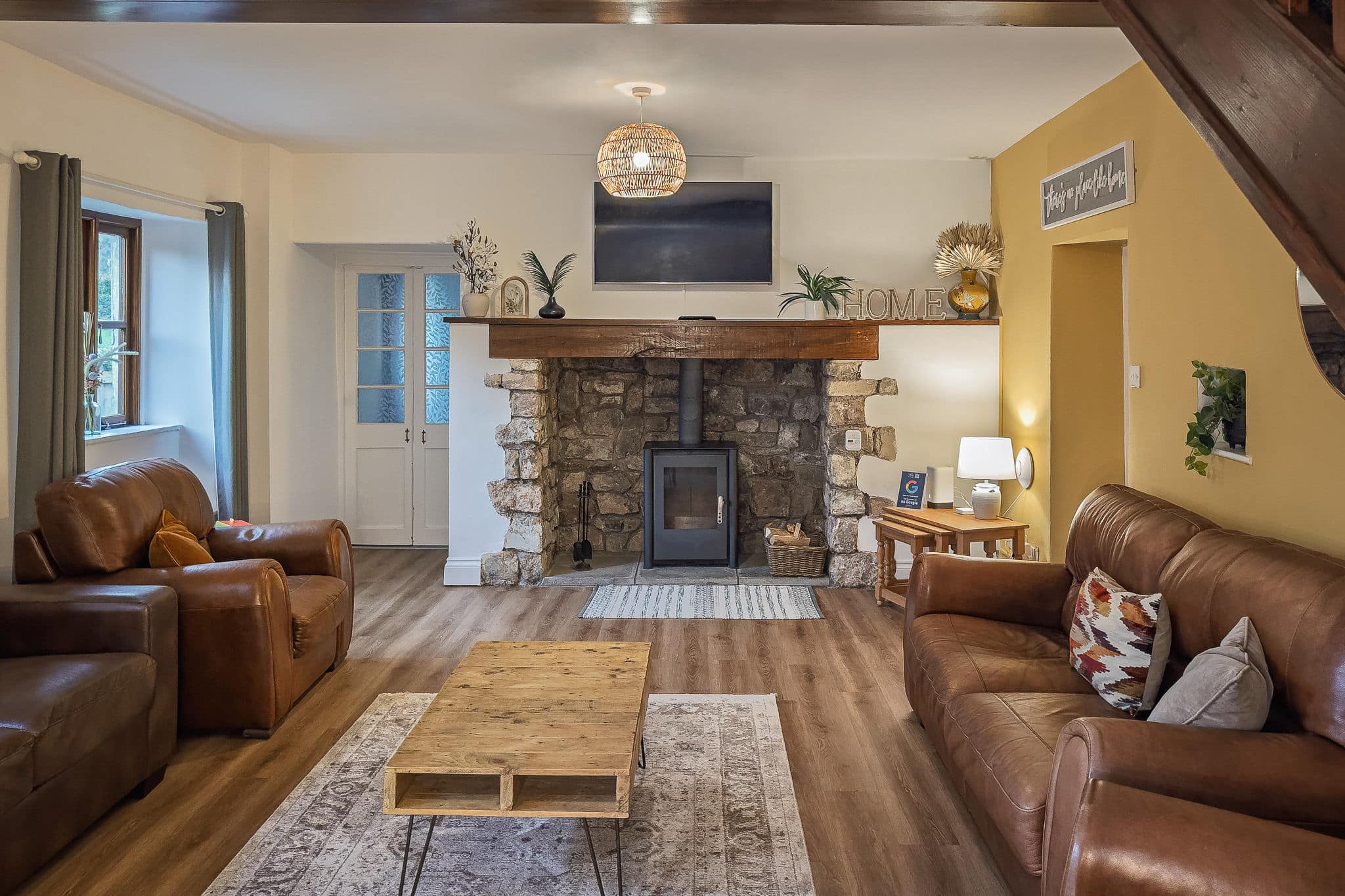 Living room with log burner at Inglenook Cottage
